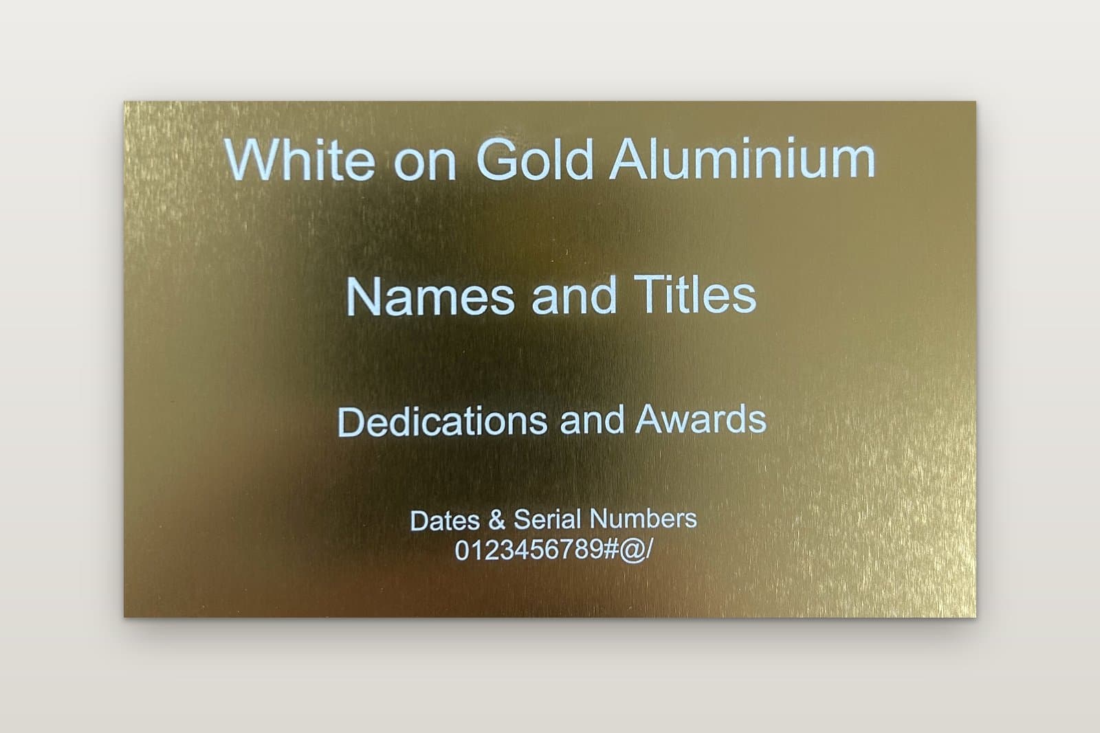 Engraved gold anodised aluminium plate with white lettering